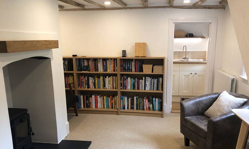 A new room, with bookcases, carpets and all is clean.