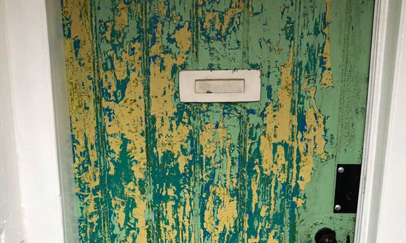 Front door, paint peeling.